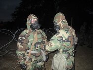 Marines from 6th Marine Regiment, 2nd Marine Division looking each other over during a CBRN drill.

