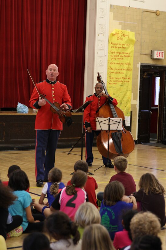 A string duo comprised of MGySgt Peter Wilson and MSgt Aaron Clay performed a Music in the Schools program at Murch Elementary School in Washington, D.C., Nov. 1, 2013. The Marine Band performed for approximately 8,000 students during its Music in the Schools Program, held throughout October. 