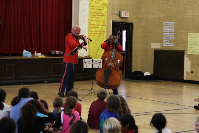 A string duo comprised of MGySgt Peter Wilson and MSgt Aaron Clay performed a Music in the Schools program at Murch Elementary School in Washington, D.C., Nov. 1, 2013. The Marine Band performed for approximately 8,000 students during its Music in the Schools Program, held throughout October. 