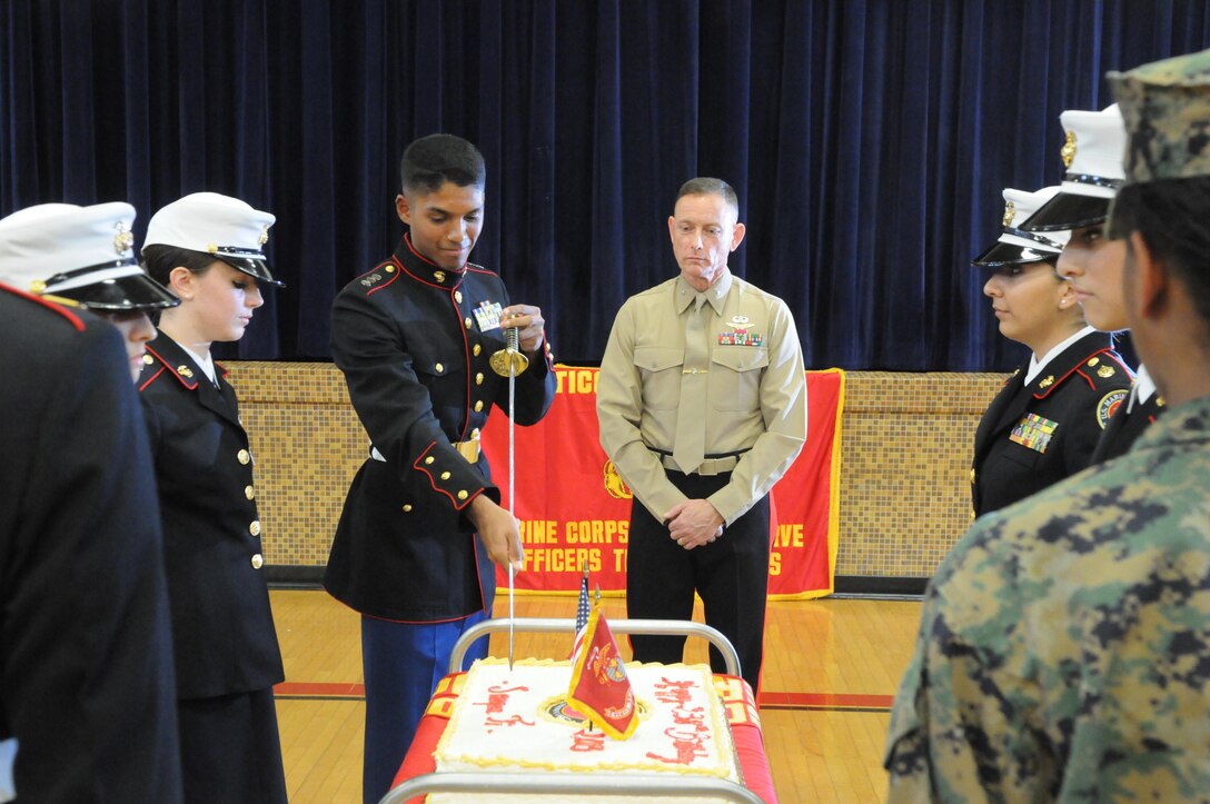 Jeremiah, commanding officer of Quantico Middle/High School’s Marine Corps Junior ROTC battalion, cuts the first piece from the Marine Corps birthday cake as Brig. Gen. Frank Kelley, commanding general of Marine Corps Systems Command, looks on at the school’s 2013 Junior ROTC Marine Corps Birthday Ceremony on Nov. 7. 