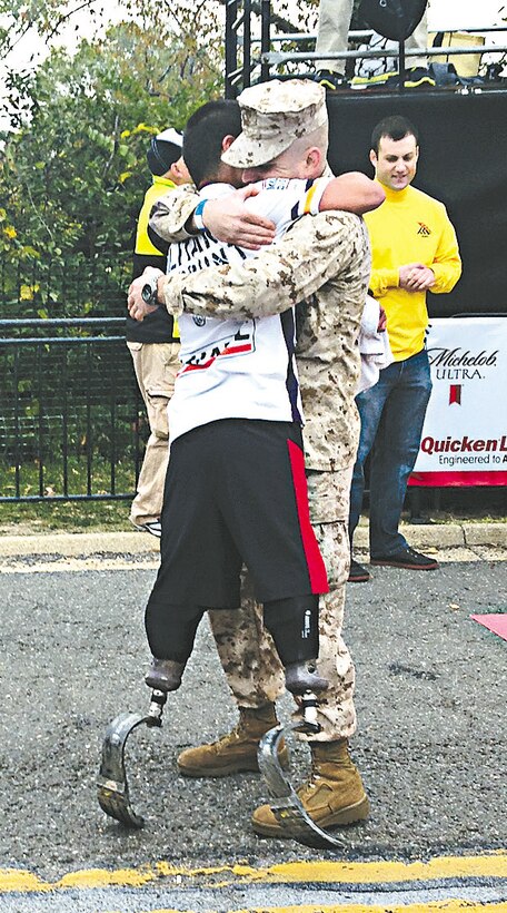 Former Cpl. Carlos Torres embraces 2nd Lt. Brian Parker, his onetime platoon sergeant, at the Marine Corps Marathon 10K finish line. It was Quantico's most popular picture from the event. 