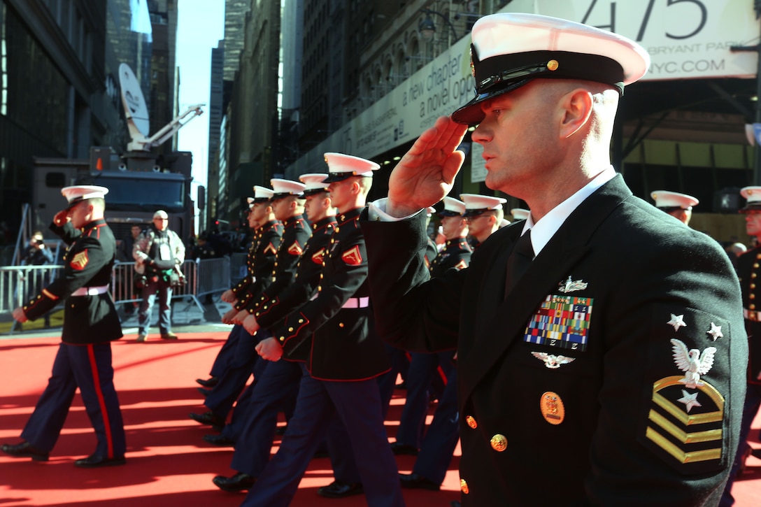 Master Chief Petty Officer Shawn Isbell, the command master chief of the USS New York, leads Marines and sailors from the ship in the Veterans Day parade in New York City Nov. 8, 2013. The large parade went right through Manhattan, with thousands lining the sides of the streets yelling, chanting and cheering on the service members as they marched by.