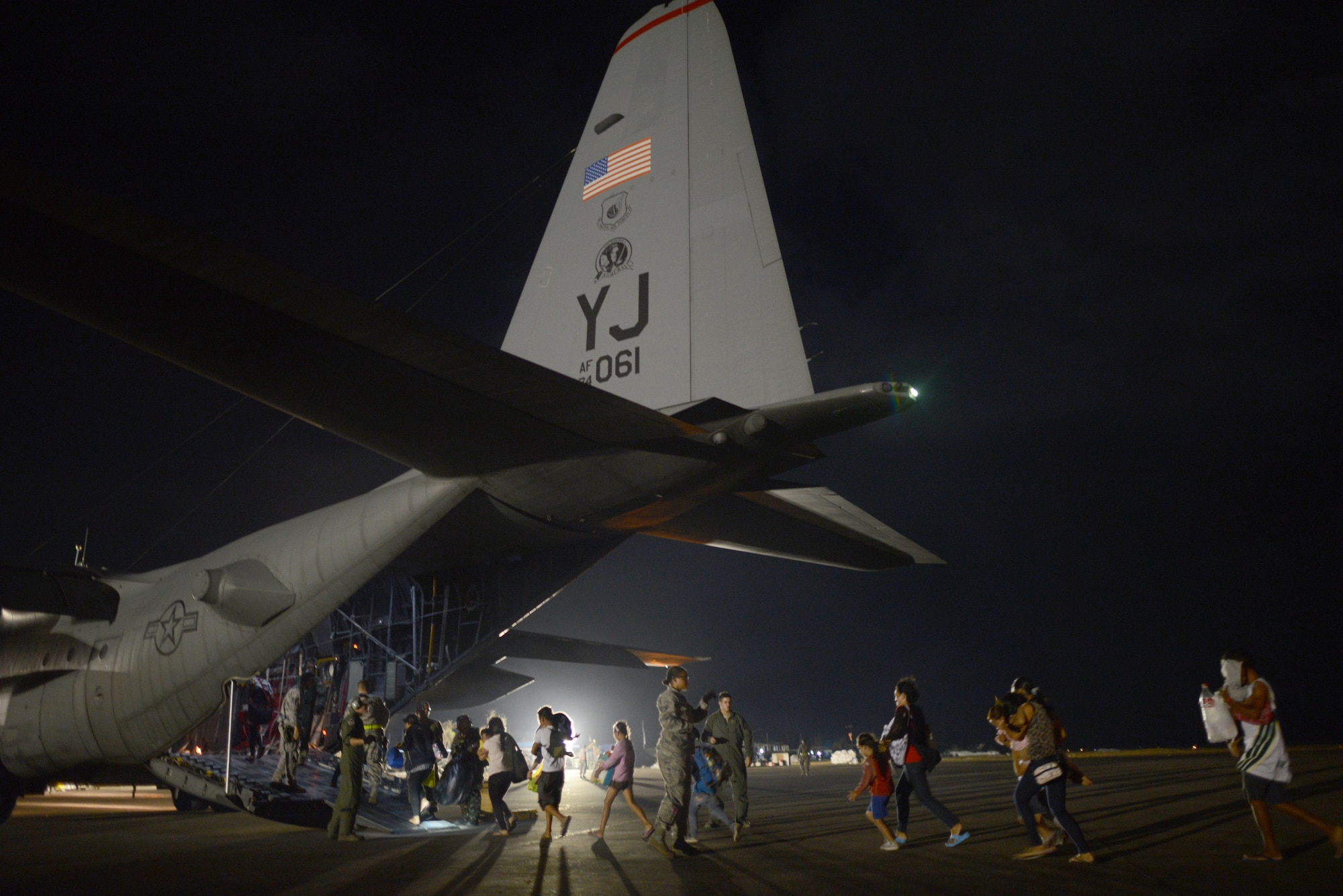 Evacuees board an Air Force C-130 Hercules Nov. 18, 2013, at Tacloban Airport, Republic of the Philippines, during Operation Damayan. The evacuation process was overseen by a joint service operation and the Armed Forces of the Philippines.