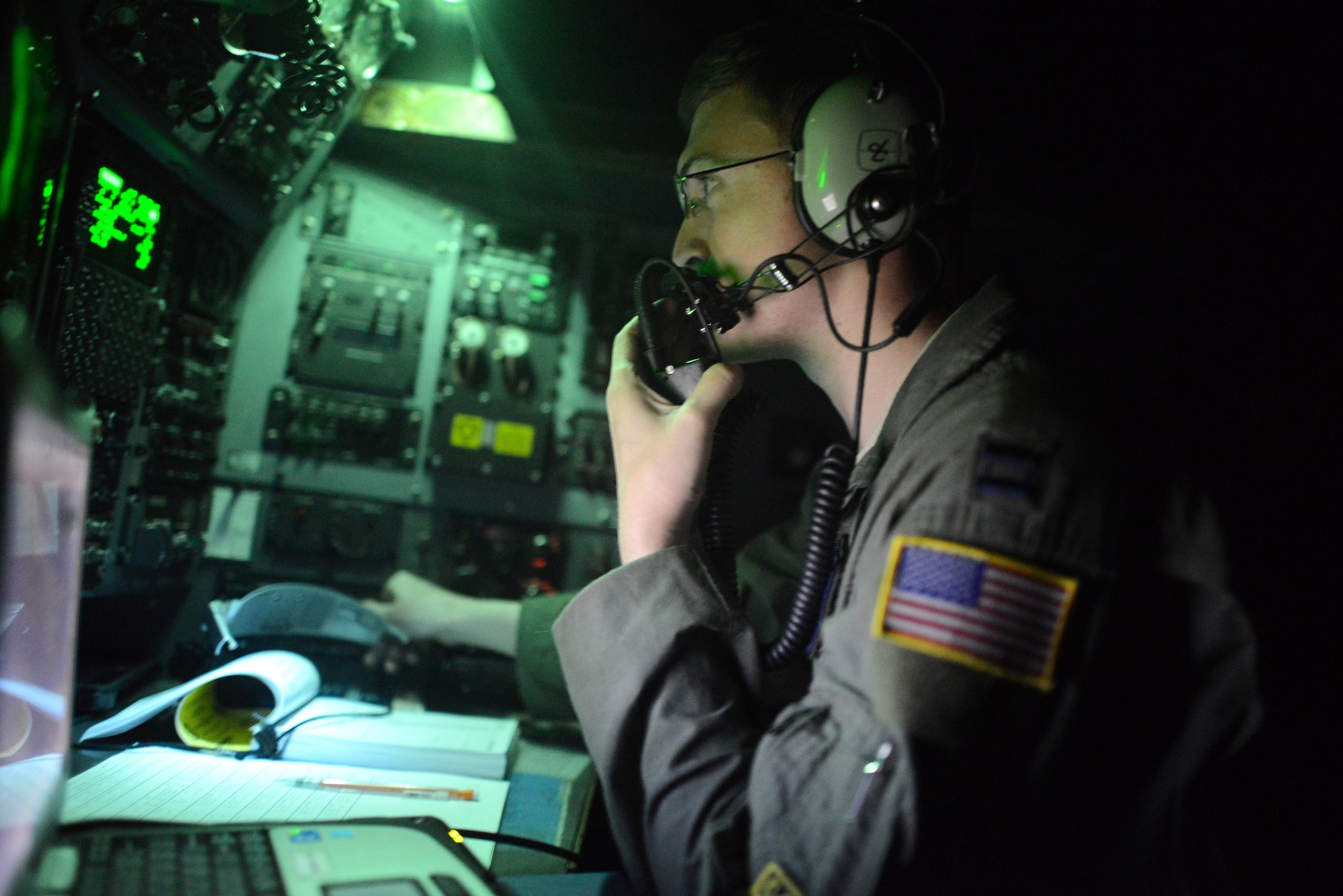 Capt. Jake Morton, a C-130 Hercules aircraft navigator assigned to the 36th Airlift Squadron, Yokota Air Base, Japan, monitors radio traffic Nov. 18, 2013, on approach to Tacloban Airport during Operation Damayan. 