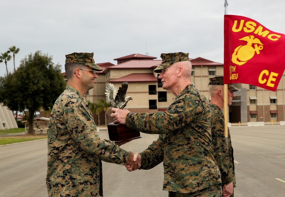 Lieutenant Gen. John A. Toolan, right, commanding general, I Marine Expeditionary Force, presents Maj. Eric J. Taylor, logistics officer, 15th Marine Expeditionary Unit, with The Navy and Marine Association Leadership Award for 2012 during an award ceremony aboard Camp Pendleton, Calif., Nov. 19. The award recognizes Marines for leadership in their organization and is voted on by their peers. Taylor, 35, is from La Habra Heights, Calif. (U.S. Marine Corps photo by Cpl. Emmanuel Ramos/Released)