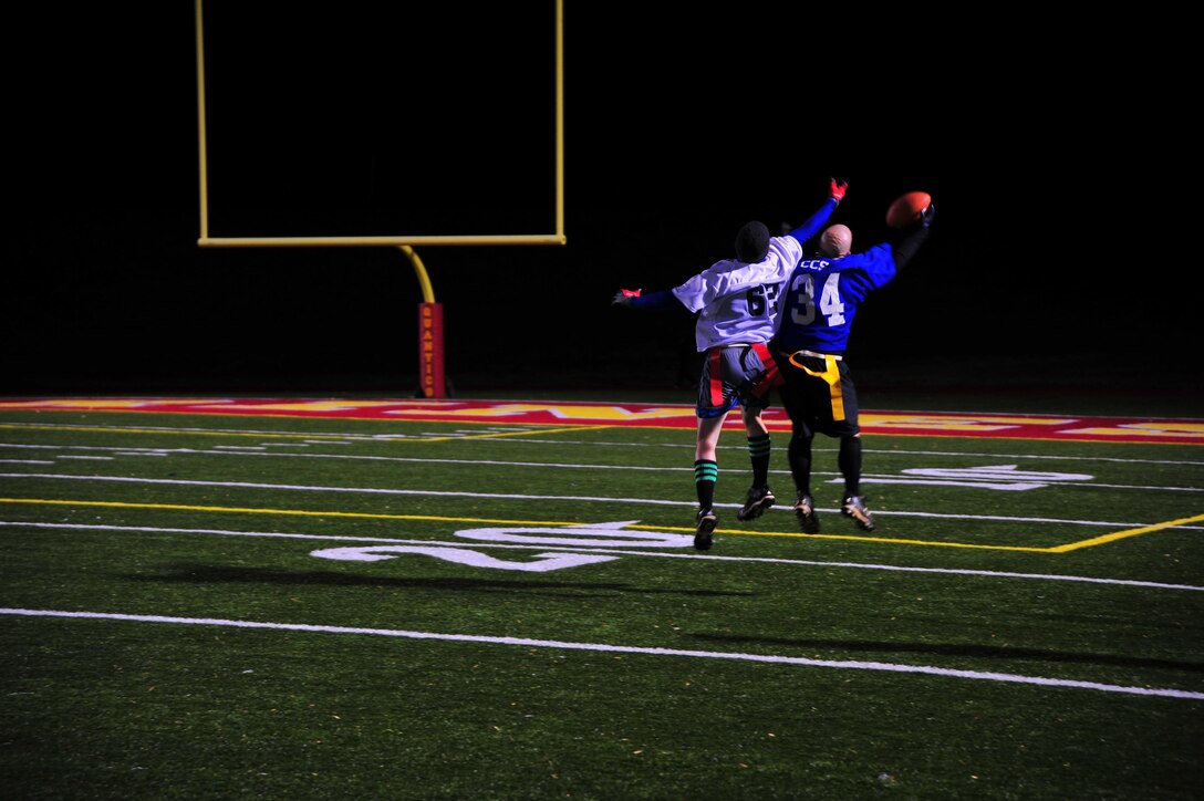 Players from the MCIA Bulldogs and TBS Logistic Support Group teams fight for the ball during an intramural flag football game held at Butler Stadium aboard Marine Corps Base Quantico on Nov. 14, 2013. TBS LSG defeated the Bulldogs 22-8. 
