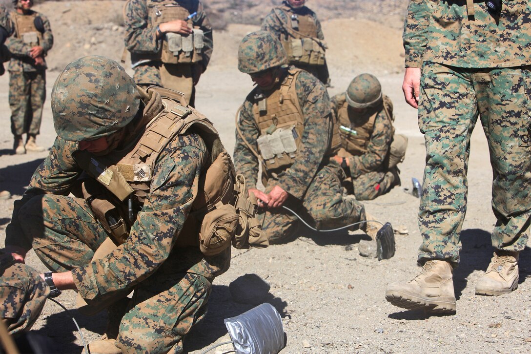 Marines with Combat Logistics Regiment 17 and Combat Logistics Battalion 15, 1st Marine Logistics Group, place field-expedient claymore mines during a basic demolitions course aboard Camp Pendleton, Calif., Nov. 14, 2013. Approximately 44 Marines from 1st MLG participated in the three-day training course and received instruction on demolitions as well as combat life saving techniques, patrolling and radio operations.