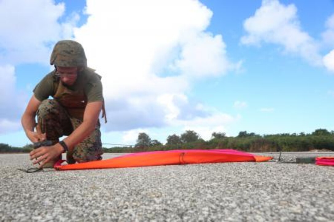 Lance Cpl. Jessie B. Vangelder hammers in a VS-17 platform into Tinian’s Backer Runway at North Field Nov. 19, during Exercise Forager Fury II. The VS-17 platforms allow aircraft pilots to have a visual aid when landing on a runway. Vangelder is a navigational aids technician and Marine Air Traffic Controller Mobile Team member from Pittsburgh, Pa., with Marine Air Control Squadron 4, Marine Air Control Group 18, 1st Marine Aircraft Wing, III Marine Expeditionary Force.
