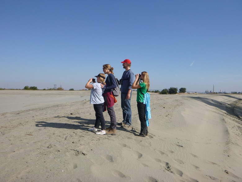 Visitors stand atop newly dredged river sand at the Antioch Dunes National Wildlife Refuge in Antioch, Calif., Nov. 9, 2013, the result of a unique partnership among the U.S. Fish and Wildlife Service, the U.S. Army Corps of Engineers Sacramento District and the Port of Stockton. The sand – dredged from the Stockton Deep Water Ship Channel to ensure navigability – will help restore the Antioch Dunes ecosystem, creating habitat on the refuge for such endangered species as the Lange’s metalmark butterfly, the Antioch Dunes Evening Primrose and the Contra Costa Wallflower. 