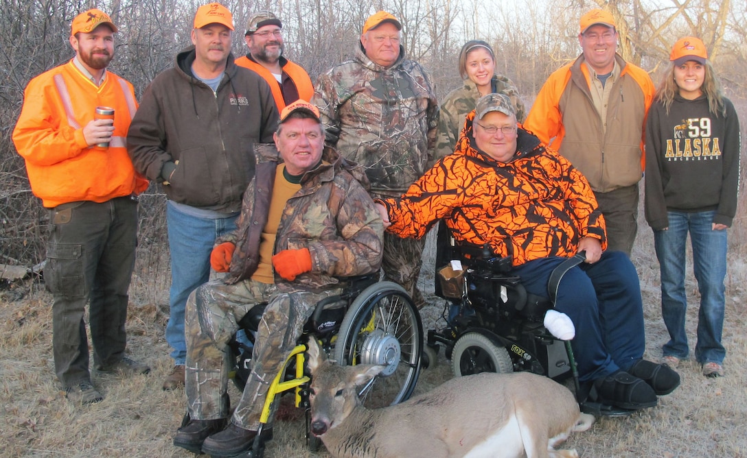 Handicapped Hunter Dean Westfall, left is joined by his hunting buddy Jim Dekay with his whitetail doe, during the Annual Oahe Hunt, held Nov. 18, 2012. Backing them up are, from left Erik Richter, Henry (Tuck) Durham, Greg Stluka, Lowell Somsen, Molly Tschetter, Pat Buscher and Sydney McLaury. The 2013 hunt will take place Nov. 23-24 near the Oahe Downstream Recreation Area.