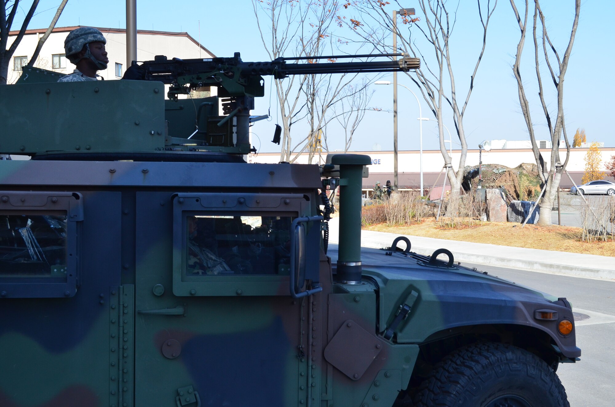 OSAN AIR BASE, Republic of Korea  – Pvt. Deondrik Lewis (top) and Staff Sgt. Daniel Ortiz, both with the 35th Air Defense Artillery Brigade, provide security from a high mobility multi-purpose wheeled vehicle, or “humvee,” with an M-2 .50 caliber machine gun nearby an Air Force checkpoint in the background during the  Beverly Bulldog exercise here, Nov. 20.
The Air Defenders participated in the exercise as part of their 'Dragon Warrior Wednesday' training event which kicked off early in the morning with a six-mile road march.
(U.S. Army Photo by Spc. Shawn Denham, PAO, 35th ADA)
