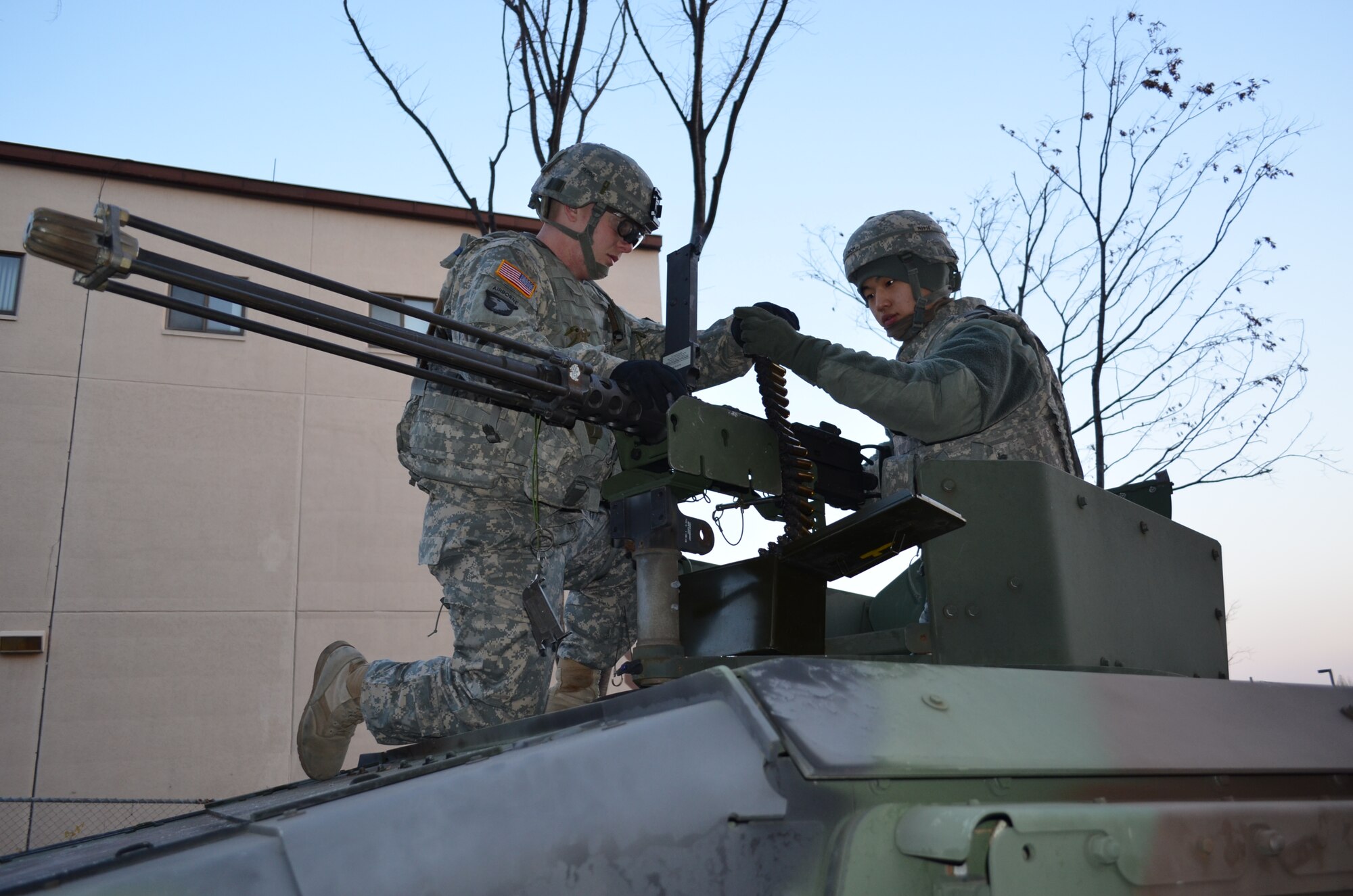 OSAN AIR BASE, Republic of Korea  – Sgt. Justin Spaunhorst (left) and Cpl. Noh, Young-Chan(right), both with the 35th Air Defense Artillery Brigade, load an M-2 .50 caliber machine gun with blank rounds outside of the brigade's headquarters during the Beverly Bulldog exercise here, Nov. 20. This is the first time the Dragon Brigade has participated in the exercise. Tough, realistic training in such combat activities as providing security, erecting barricades and engaging opposing forces puts the personnel in as close to a real-world scenario as possible. (U.S. Army Photo by Spc. Shawn Denham, PAO, 35th ADA)
