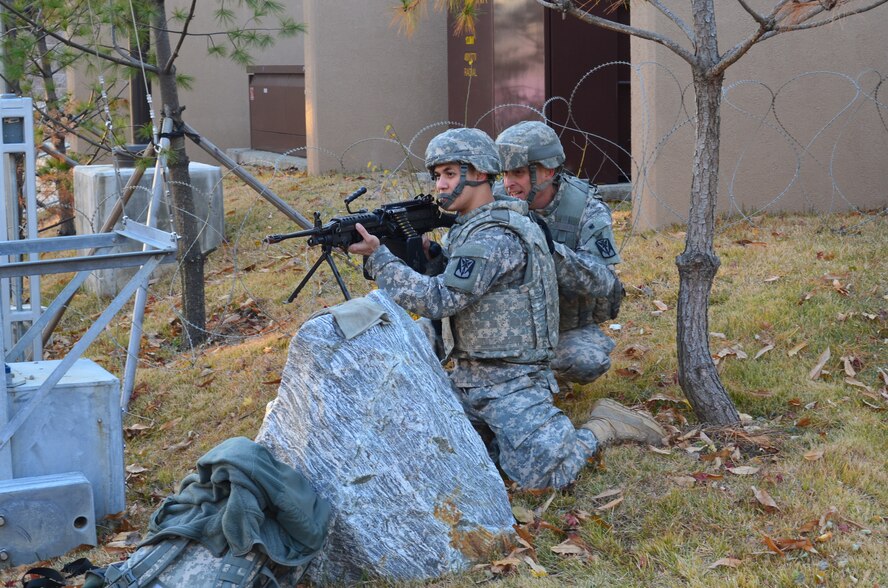 OSAN AIR BASE, Republic of Korea  – Sgt. Maj. James Brazill (right), operations sgt. maj. with the 35th ADA Brigade, directs Spc. Francis Calvendra as he fires his M-249 squad automatic weapon at opposing forces, or “OPFOR,” during the Beverly Bulldog exercise here, Nov. 20. The exercise is a regular event for the 51st Fighter Wing stationed on the air base and includes the Air Defenders for the first time in an effort to integrate the units into training and defense of the air base, just as it would happen during war. (U.S. Army Photo by Spc. Shawn Denham, PAO, 35th ADA)
