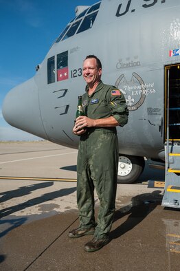 Lt. Col. Scott Wilson, a C-130 pilot in the 123rd Airlift Wing, stands by the crew door of his aircraft at the Kentucky Air National Guard Base in Louisville, Ky., after being doused with water and champagne by his colleges upon completion of his final, or “fini,” flight in the Hercules transport aircraft Nov. 20, 2013. Wilson, who has served in the U.S. Air Force and Air National Guard for 26 years, is set to retire Jan. 31, 2014. (U.S. Air National Guard photo by Maj. Dale Greer)