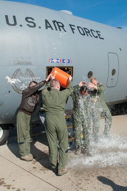 Members of the 123rd Airlift Wing douse Lt. Col. Scott Wilson, a Kentucky Air National Guard C-130 pilot, with water as he exits the aircraft for the last time at the Kentucky Air National Guard Base in Louisville, Ky., on Nov. 20, 2013. Wilson, who is set to retire Jan. 31, 2014, was completing his final, or “fini,” flight. (U.S. Air National Guard photo by Maj. Dale Greer)