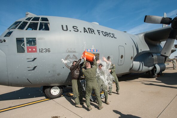 Members of the 123rd Airlift Wing douse Lt. Col. Scott Wilson, a Kentucky Air National Guard C-130 pilot, with water as he exits the aircraft for the last time at the Kentucky Air National Guard Base in Louisville, Ky., on Nov. 20, 2013. Wilson, who is set to retire Jan. 31, 2014, was completing his final, or “fini,” flight. (U.S. Air National Guard photo by Maj. Dale Greer)