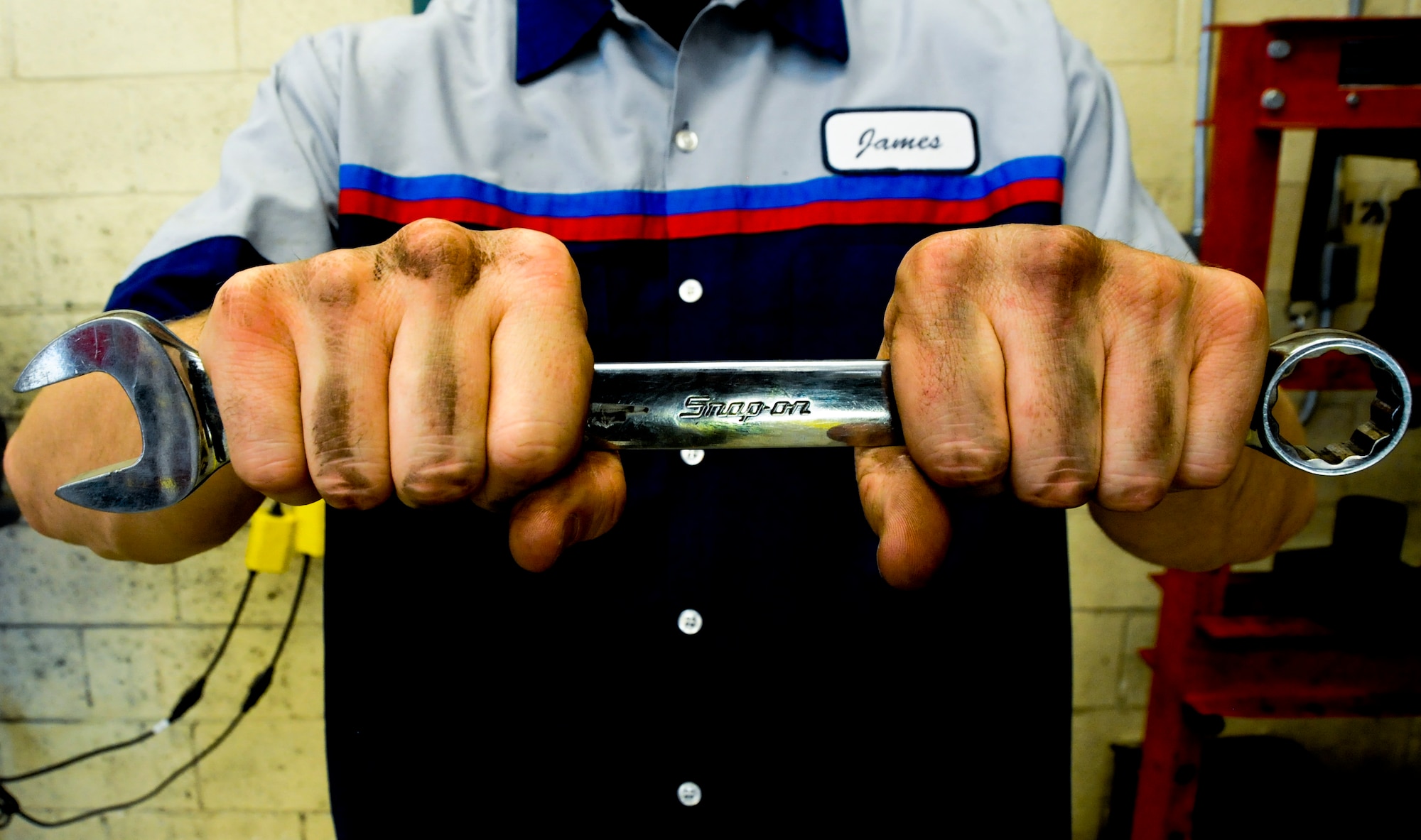 James Barnes, mechanic, holds a combination wrench during his shift at Davis-Monthan Air Force Base, Ariz., Nov. 14, 2013. Barnes works at an auto hobby shop, which gives Airmen a chance to rent out space and tools to work on their cars during their spare time. (U.S. Air Force photo by Senior Airman Sivan Veazie/Released)