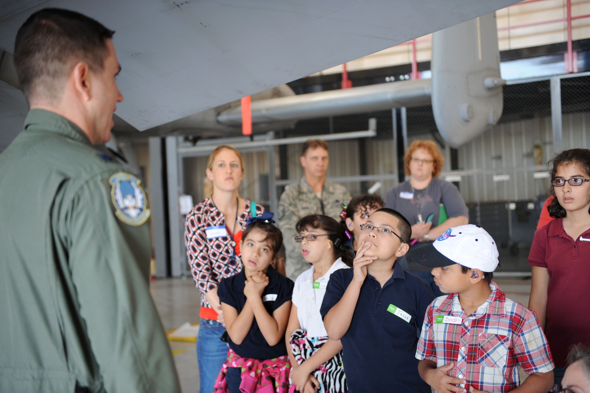 Students from the Arizona School for the Deaf and the Blind Tucson campus look up at the body of an A-10 as U.S. Air Force Lt. Col. James Krischke, 355th Operations Support Squadron A-10 pilot, speaks about the A-10 and its mission during a tour at Davis-Monthan Air Force Base, Ariz., Nov. 14, 2013. The tour was sponsored by the Southeast Regional Cooperative of the Arizona School for the Deaf and Blind to encourage camaraderie amongst the students. (U.S. Air Force photo by Airman 1st Class Saphfire Cook/released) 