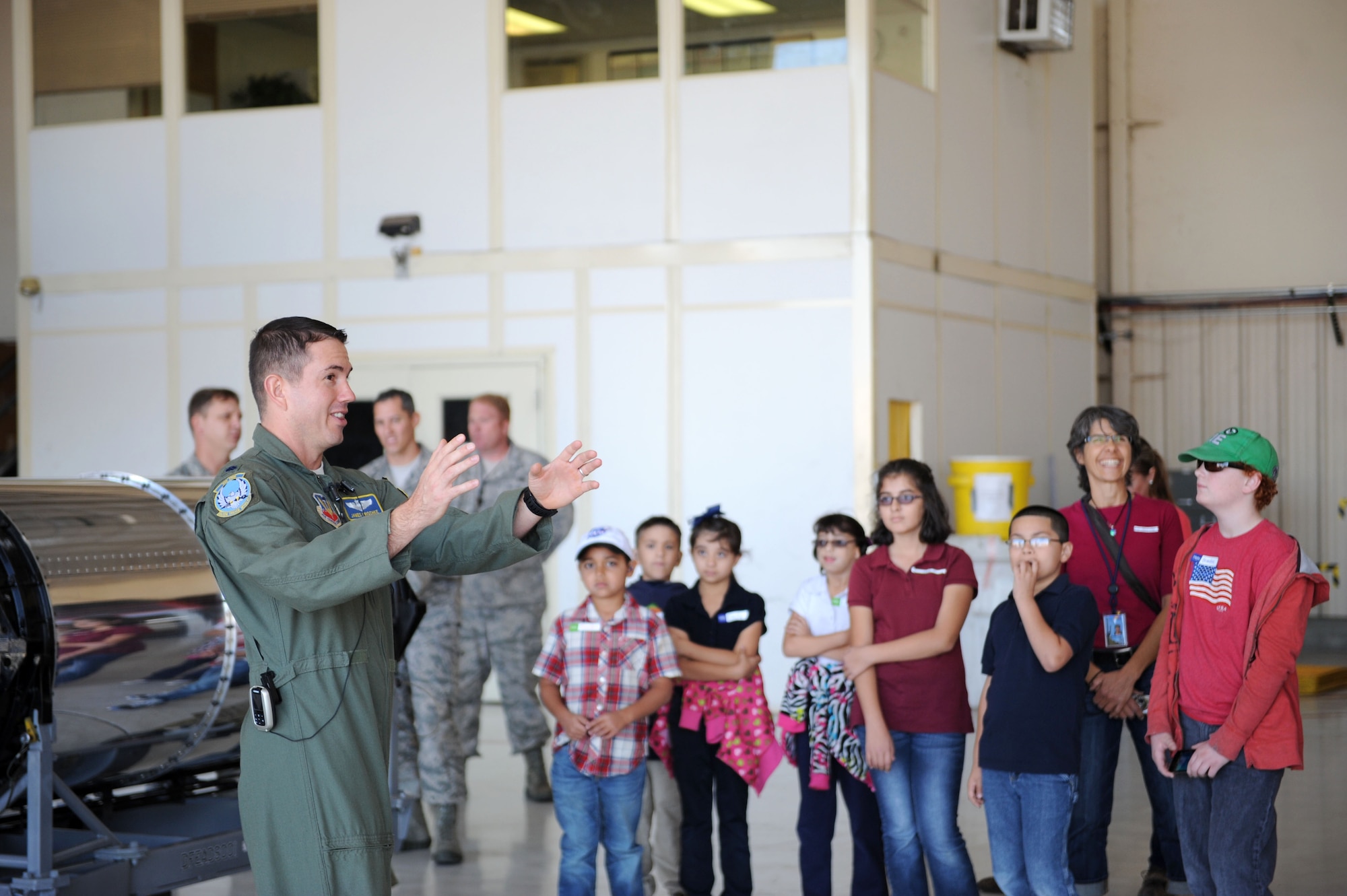 U.S. Air Force Lt. Col. James Krischke, 355th Operations Support Squadron A-10 Thunderbolt pilot, speaks about the A-10 and its mission to students from the Arizona School for the Deaf and the Blind, Tucson campus, during a tour at Davis-Monthan Air Force Base, Ariz., Nov. 14, 2013. Ten students with hearing impairments, accompanied by a few teachers and parents, were given a tour of an A-10 and shown the air traffic control tower, including the simulator and the cab. (U.S. Air Force photo by Airman 1st Class Saphfire Cook/released) 