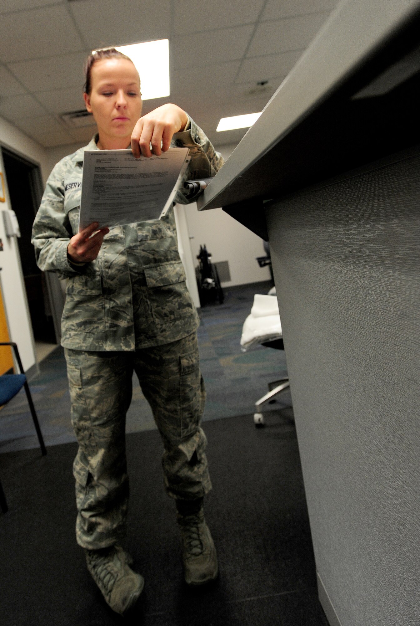 U.S. Air Force Senior Airman India Meserve, 509th Medical Operations Squadron physical therapy technician, examines patient records at Whiteman Air Force Base, Mo., Nov. 8, 2013.  Physical therapy technicians are subject matter experts who treat patients on a variety of injuries and help rehabilitate them until they are fully recovered and mission-ready. (U.S. Air Force photo by Staff Sgt. Nick Wilson/Released)