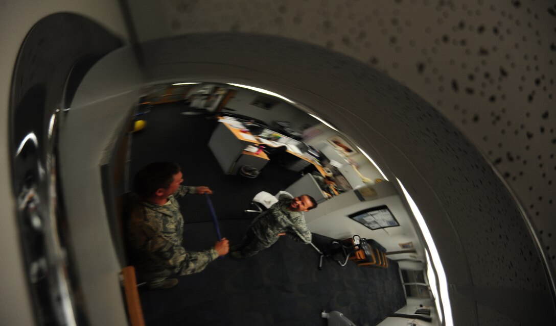 U.S. Air Force Tech. Sgt. Thomas Dawson, 509th Civil Engineer Squadron, performs a shoulder-strengthening exercise with assistance from U.S. Air Force Senior Airman India Meserve, 509th Medical Operations Squadron physical therapy technician at Whiteman Air Force Base, Mo., Nov. 8, 2013.  According to Meserve, physical therapy restores muscular function and helps prevent future disabilities. (U.S. Air Force photo by Staff Sgt. Nick Wilson/Released)