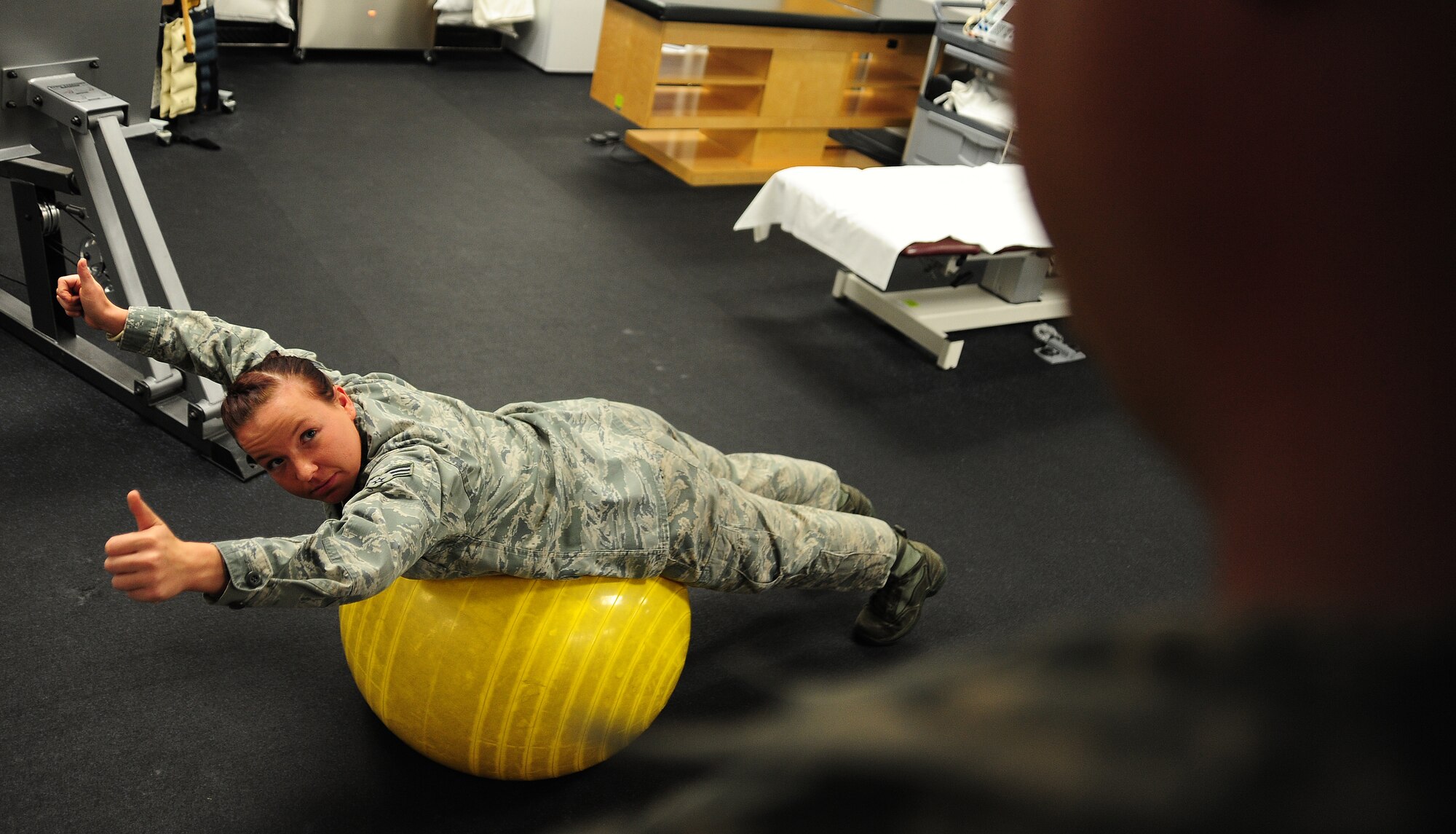 U.S. Air Force Senior Airman India Meserve, 509th Medical Operations Squadron physical therapy technician, gives instructions on a shoulder exercise to a patient at Whiteman Air Force Base, Mo., Nov. 8, 2013. This exercise strengthens the rotator cuff, which can help reduce shoulder pain and provide better range of motion. (U.S. Air Force photo by Staff Sgt. Nick Wilson/Released)