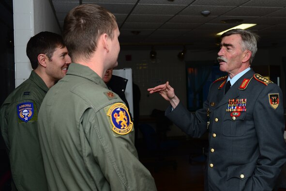General Hans-Lothar Domröse, Commander Joint Force Command Brunssum German Army, speaks to Maj. Wiley Semrau, 351st Expeditionary Air Refueling Squadron commander, and Capt. Eric Barada, 37th Expeditionary Airlift Squadron commander, after a United States Air Force mission brief during a tour at Keflavik International Airport, Iceland, Nov. 19, 2013. The 48th Air Expeditionary Group conducts tours to highlight and further explain why the U.S. Air Force supports air policing and surveillance missions while deployed to Iceland. (U.S. Air Force photo by Airman 1st Class Dana J. Butler/Released)