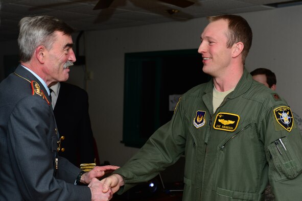 General Hans-Lothar Domröse, Commander Joint Force Command Brunssum German Army, shakes hands with Maj. Barak Amundson, 493rd Expeditionary Fighter Squadron pilot, after a United States Air Force mission brief during a tour at Keflavik International Airport, Iceland, Nov. 19, 2013. The 48th Air Expeditionary Group conducts tours to highlight and further explain why the U.S. Air Force supports air policing and surveillance missions while deployed to Iceland. (U.S. Air Force photo by Airman 1st Class Dana J. Butler/Released)