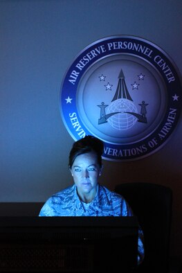 Master Sgt. Loy Brown, superintendent, officer promotion eligibility, sets up a terminal for use in the promotion board room at Air Reserve Personnel Center, Buckley Air Force Base. The secretariat facilitates officer promotion boards for the U.S. Air Force. (U.S. Air Force photo/Master Sgt. Christian Michael)