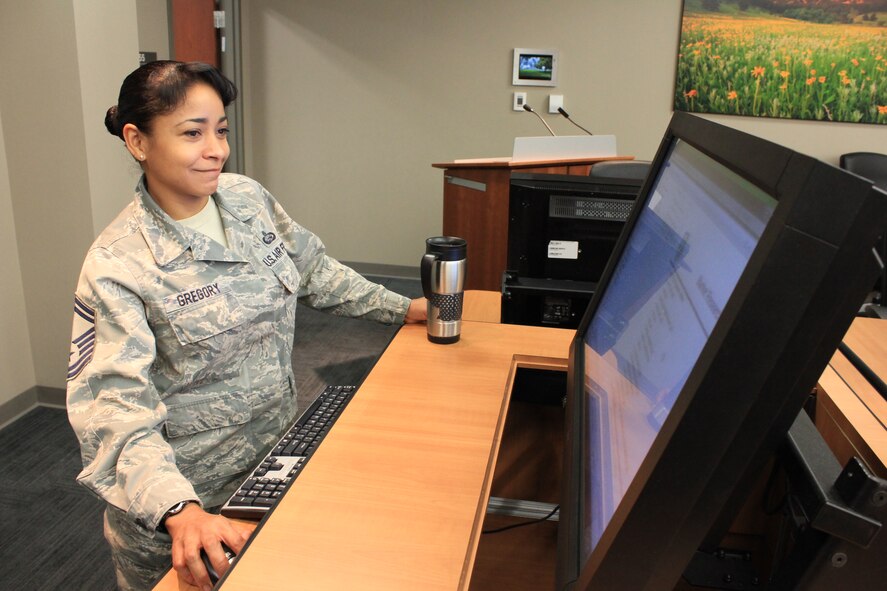 Senior Master Sgt. Bernadette Gregory, superintendent, Reserve of the Air Force Selection Board Secretariat, sets up a terminal for use in the promotion board room at Air Reserve Personnel Center, Buckley Air Force Base. The secretariat facilitates officer promotion boards for the U.S. Air Force. (U.S. Air Force photo/Master Sgt. Christian Michael)