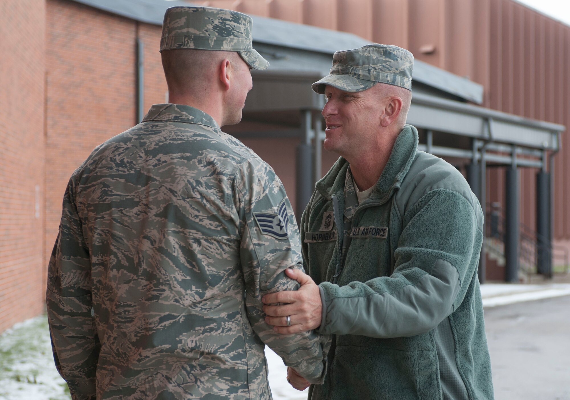 Chief Master Sgt. Brian Hornback, command chief for Air Force Global Strike Command, greets Staff Sgt. Joshua Hull, 5th Force Support Squadron noncommissioned officer in charge of installation Honor Guard, at Minot Air Force Base, N.D., Nov. 19. Hornback toured various base installations including the Combined Community Complex, where the Honor Guard trains as part of a two-day visit to the base. (U.S. Air Force photo/Senior Airman Stephanie Sauberan)