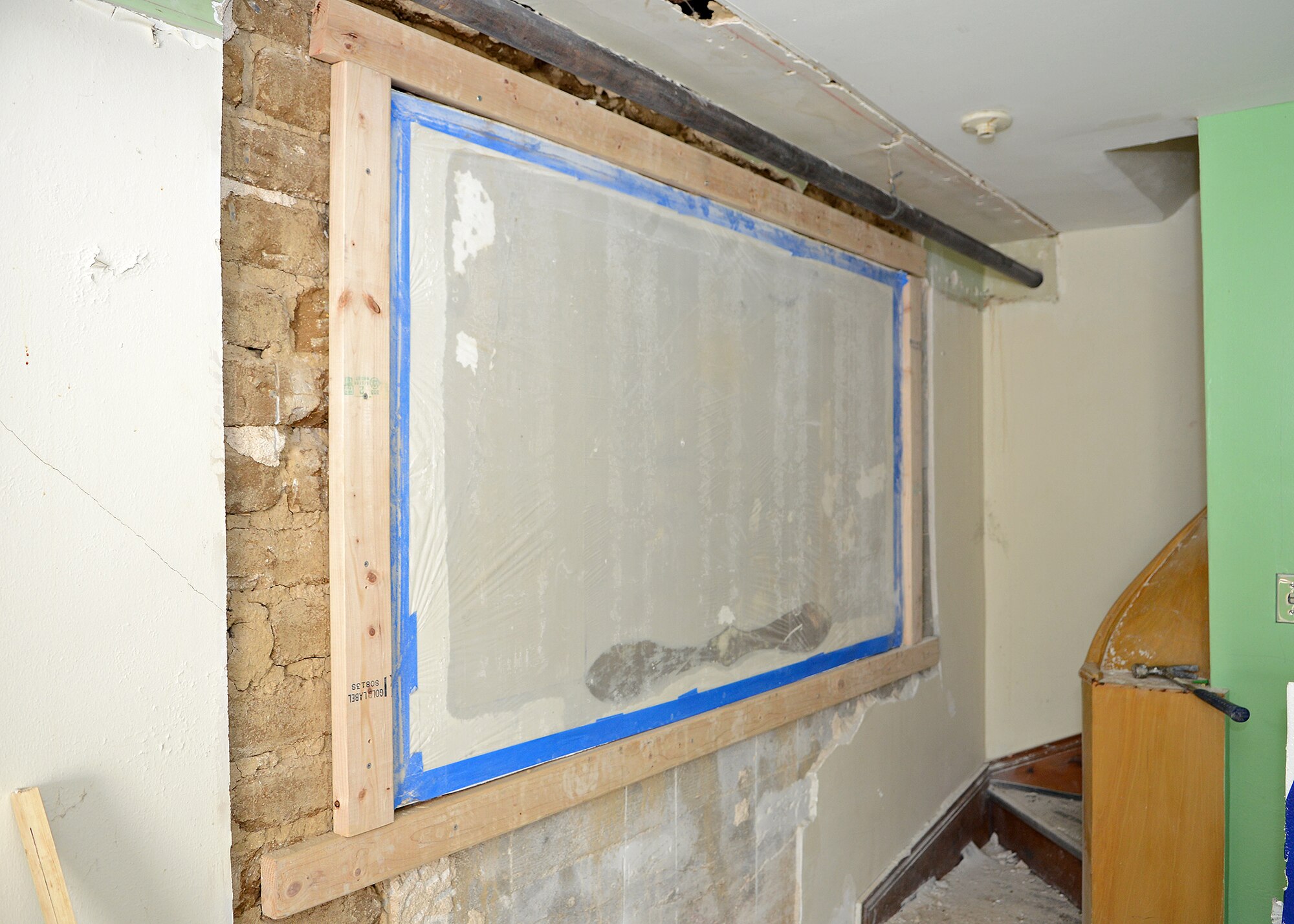 Pictured is what remains of the Muroc Manor signature wall before crews prepare to encase and protect the historic Muroc Manor signature wall from any debris during the wall’s extraction process. The signature wall potentially holds hundreds of signatures dating from the early 1940s to the 1960s. Since the wall was previously painted over, the team had to bring in an infrared camera to further evaluate the structure in order to carefully remove the wall in November. (U.S. Air Force photo by Jet Fabara) (U.S. Air Force photo by Jet Fabara)