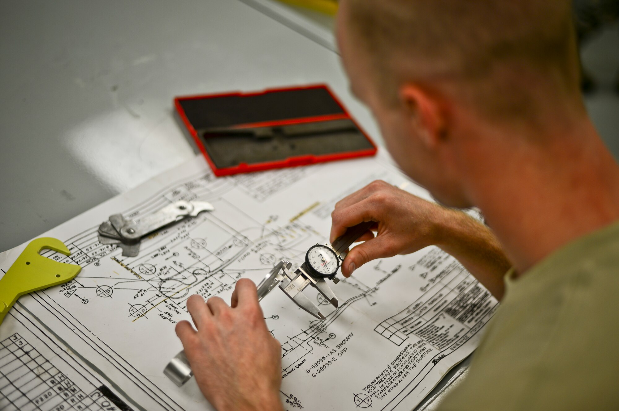 Staff Sgt. Michael Johnson, 6th Maintenance Squadron aircraft metals technology craftsman, determines if a fabricated part matches its blueprint on Nov. 5, 2013 at MacDill Air Force Base, Fla. Most of the parts for the KC-135 cannot be found in stores anymore, because the aircraft were built in the late 1950s and early 1960s – due to that fact, the parts are made at the metals technology flight. (U.S. Air Force photo by Staff Sgt. Brandon Shapiro/Released)