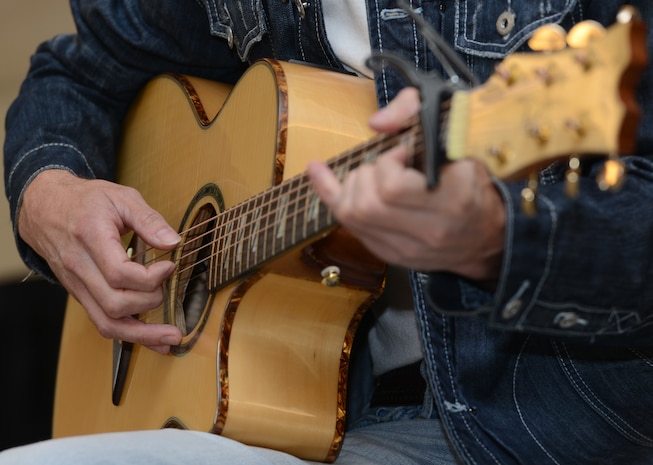 America's Got Talent contestant Jimmy Rose performs after taking pictures and shaking hands with military service members and their families Nov. 15, 2013, at Joint Base Charleston – Air Base, S.C. Rose, a country singer, songwriter and guitarist, finished in 3rd place on the shows eighth season. Rose is a U.S. Marine veteran originally from Pineville, Ky. (U.S. Air Force photo/ Airman 1st Class Chacarra Neal)
