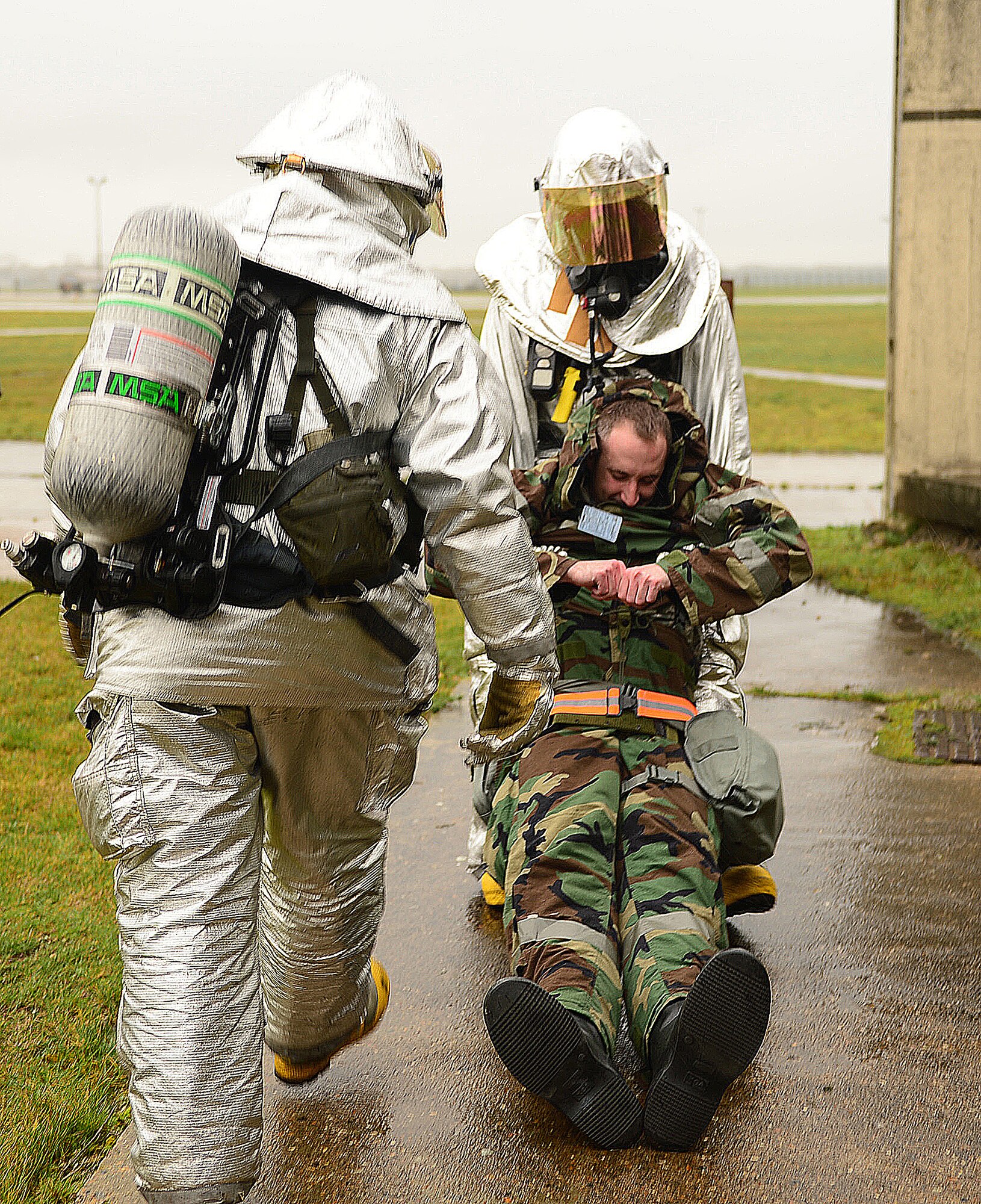 Firefighters of the 48th Civil Engineer Squadron rescue Capt. Charles Bloemendal, 48th CES readiness emergency management flight officer, after a simulated building fire during a Phase II exercise at Royal Air Force Lakenheath, England, Nov. 20, 2013. One aspect the Phase II was testing the response capabilities of Airmen through various scenarios to ensure mission readiness.  (U.S. Air Force photo by Airman 1st Class Dawn M. Weber/Released)