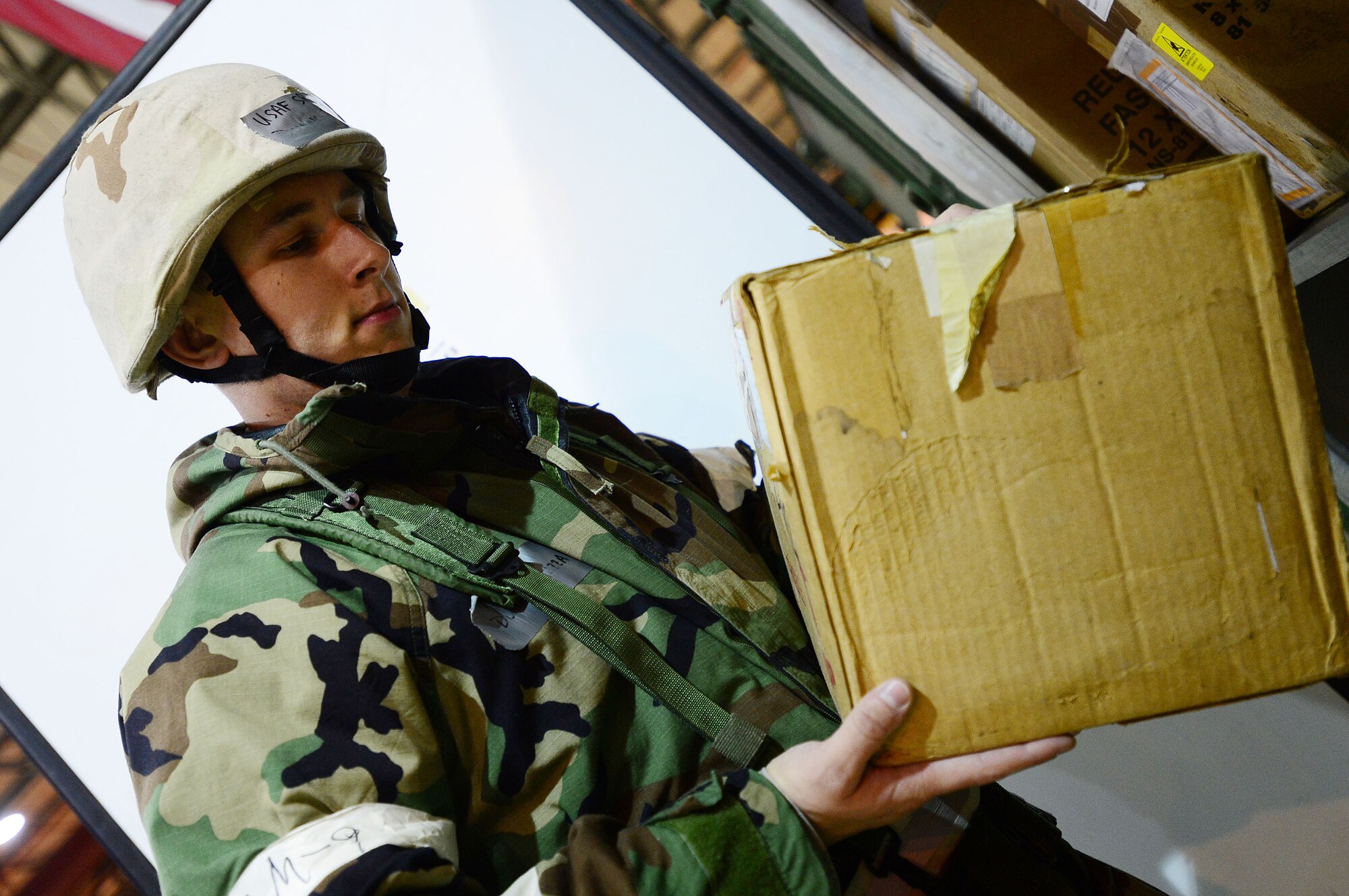 Senior Airman Dominic Piazza, 48th Logistics Readiness Squadron mobility, readiness, spares and packages journeyman, searches a storage unit for aircraft parts during a Phase II exercise at Royal Air Force Lakenheath, England, Nov. 20, 2013. The exercise tested the 48th Fighter Wing’s ability to support NATO contingency operations.  (U.S. Air Force photo by Senior Airman Tiffany M. Grigg/Released)