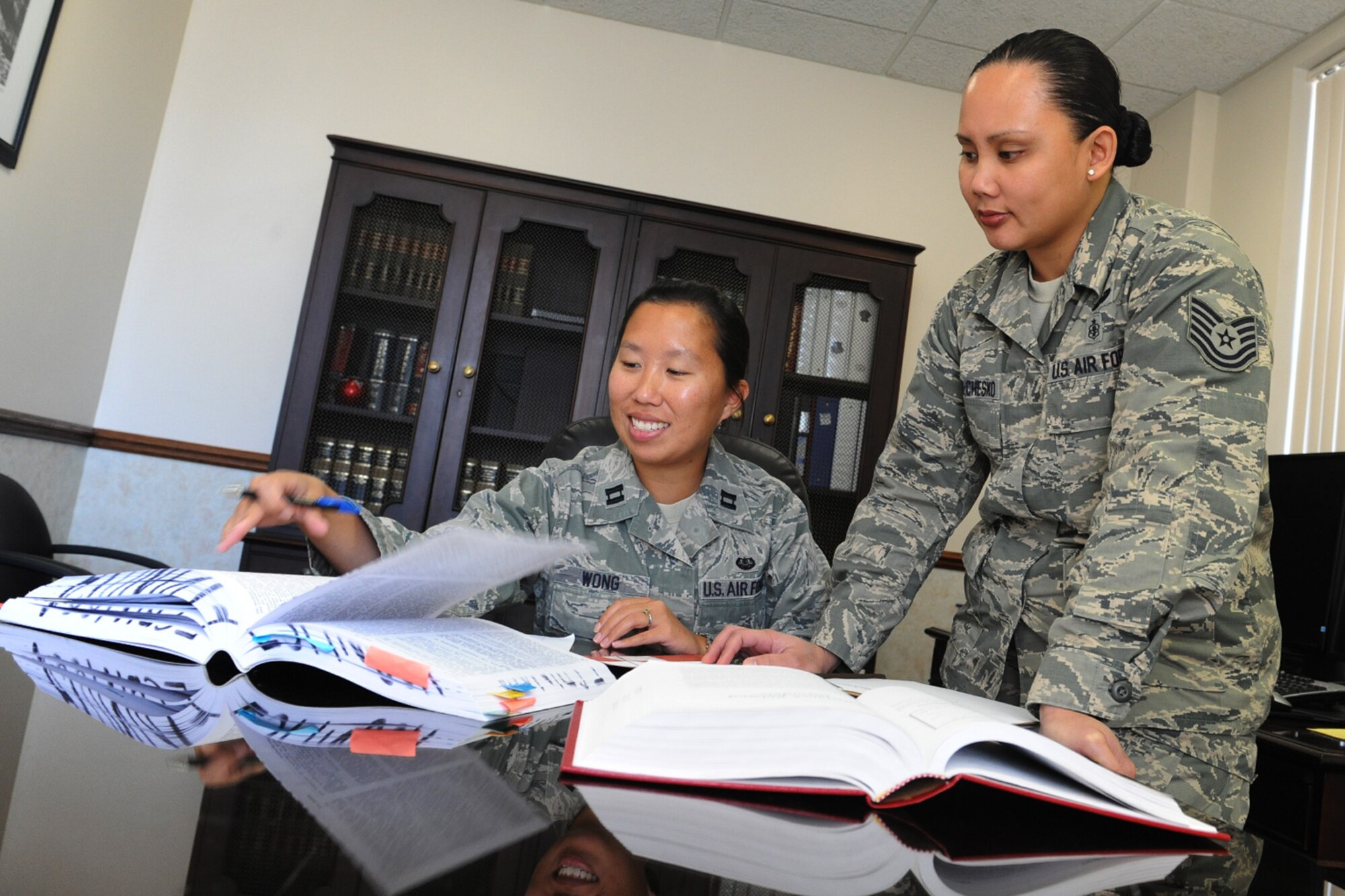 Capt. Crystal Wong, Area Defense Counsel, and Tech. Sgt. Danielle Espinosa-Chesko, defense paralegal provide legal advice to Air Force members at Scott Air Force Base who need legal representation due to administrative actions or because they are a suspect in an illegal activity.  The ADC is an experienced judge advocate who provides confidential legal advice.  (U.S. Air Force photo by Staff Sgt. Maria Bowman)