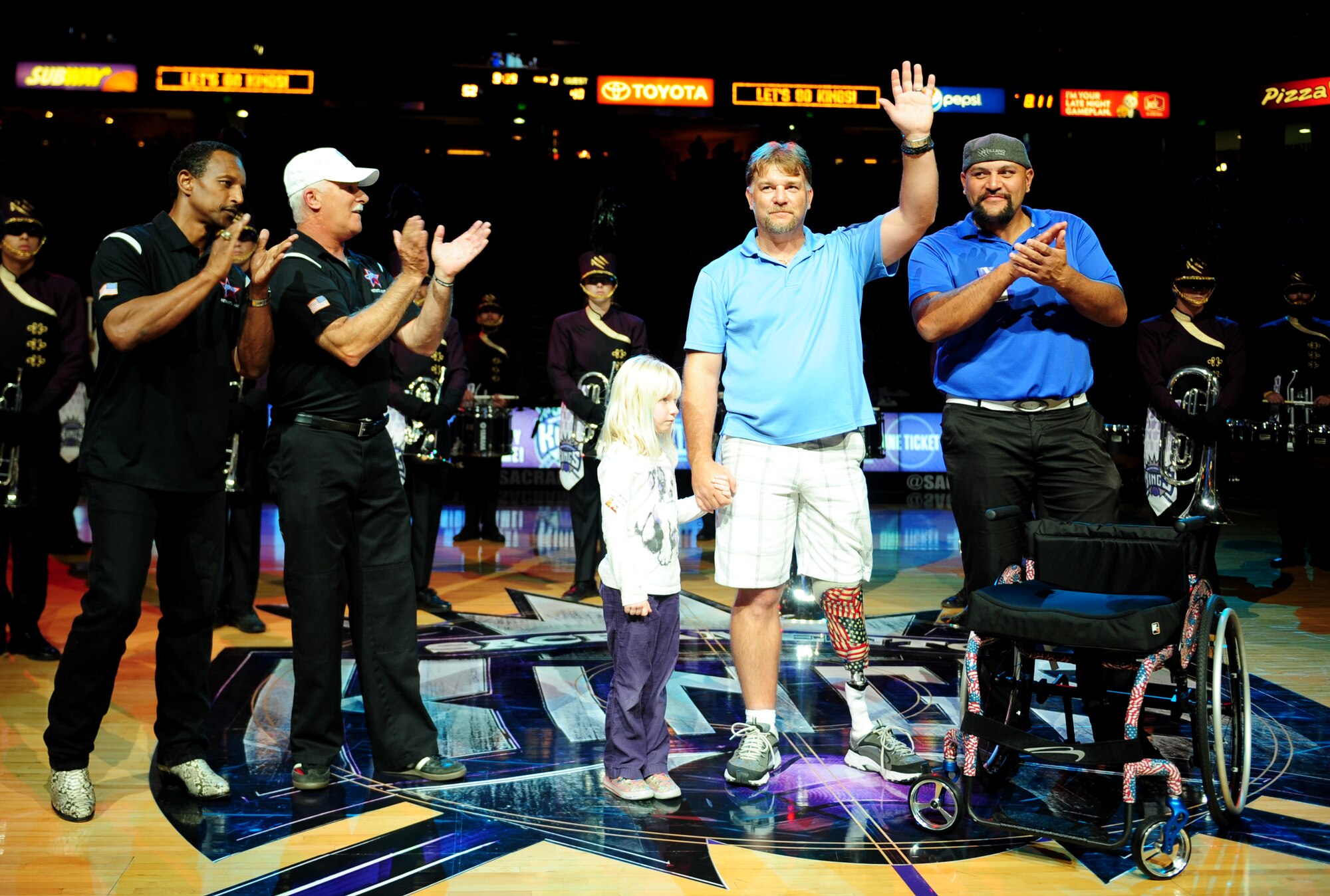 Christopher Paulsen, a disabled veteran, is presented a sports wheel-chair during a military appreciation night Nov. 13, 2013, at the Sleep Train Arena in Sacramento Calif. Chris intends to utilize the wheel-chair to compete in bowling at a national level. (U.S. Air Force photo by Airman 1st Class Bobby Cummings/Released)