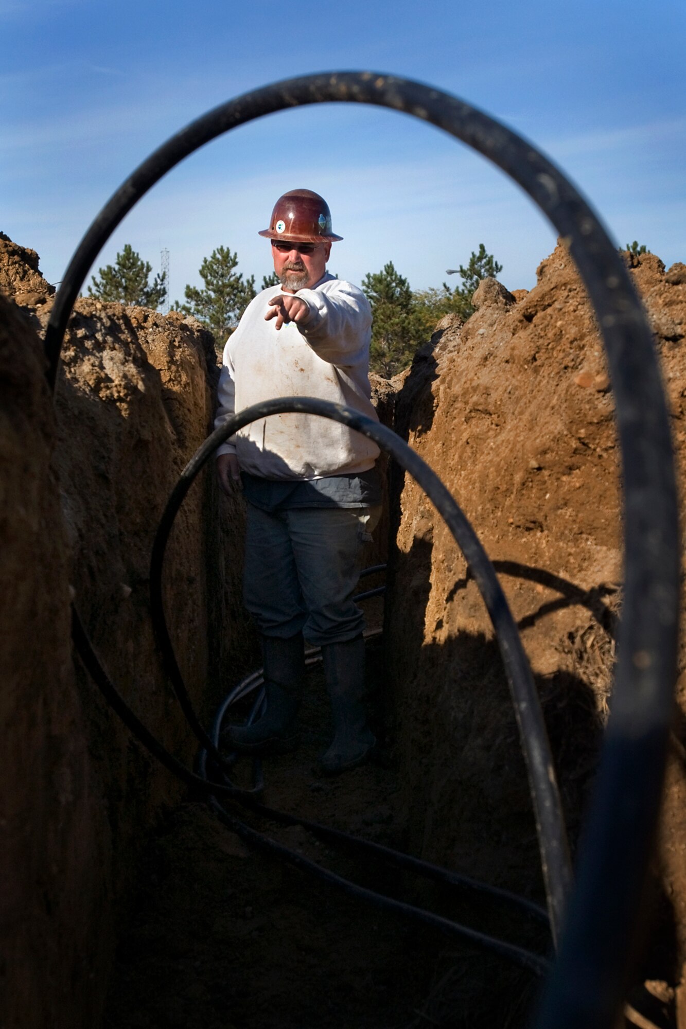 Gus Callihan, a geothermal contractor, runs supply and return lines from a well at Grissom Air Reserve Base, Ind., Oct. 22, 2013. The well is one of 28 that will be used to heat and cool Bldg. 671 following its renovation. (U.S. Air Force photo/Tech. Sgt. Douglas Hays)