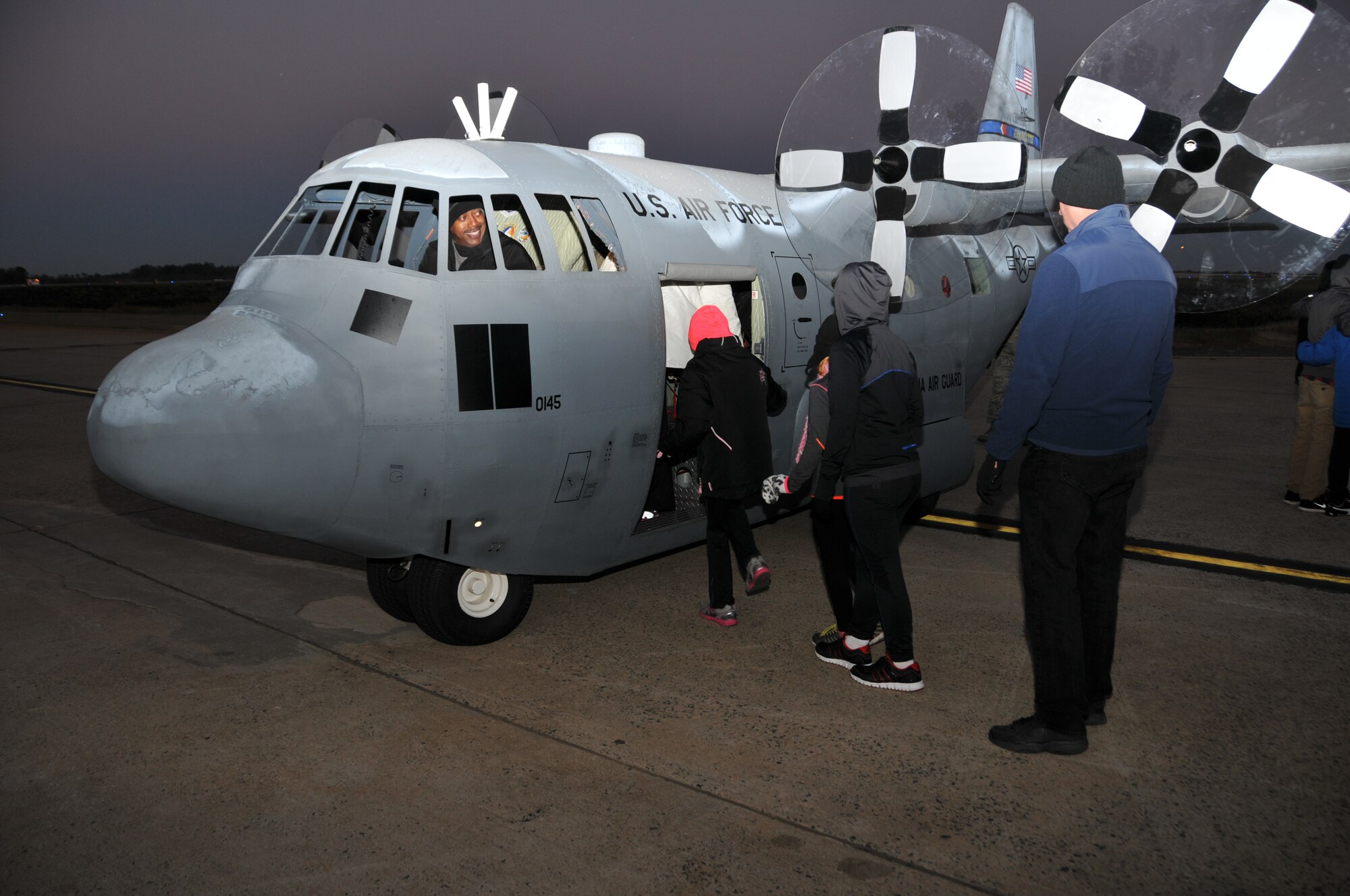 U.S. Air Force members from the 145th Maintenance Squadron, North Carolina Air National Guard give rides to children and other participants on the ever so popular Mini C-130 during the Seventh Annual 5-K Runway Walk/Run held at Charlotte-Douglas Intl. Airport, October 26, 2013.  The replicated Mini C-130 Hercules aircraft and members from the 145th Airlift Wing have supported the Annual 5-K for the last four years, giving back to the community that gives so much to the N.C. Air National Guard. (Air National Guard photo by Master Sgt. Patricia F. Moran/ Released)