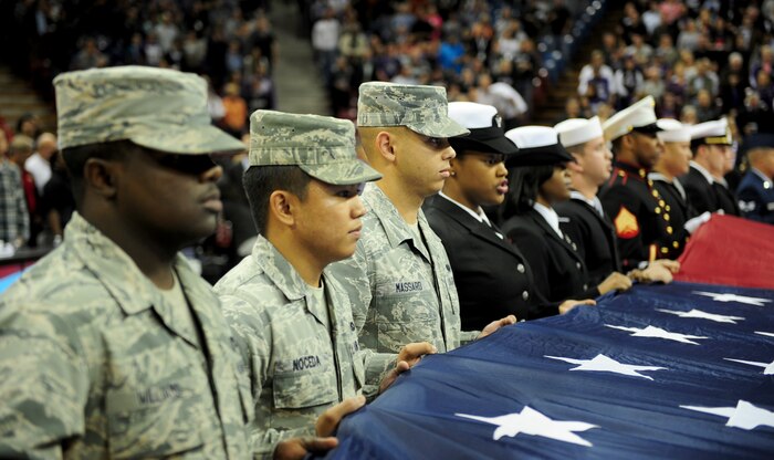Beale Airmen present the flag during the National Anthem Nov. 13, 2013, at the Sleep Train Arena in Sacramento Calif. Airmen and other service members were in attendance for a military appreciation night hosted by the Sacramento Kings basketball team. (U.S. Air Force photo by Airman 1st Class Bobby Cummings/Released)