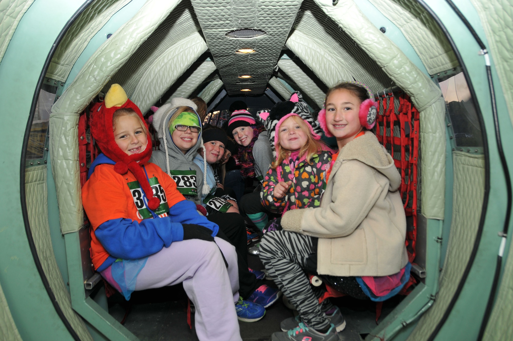 U.S. Air Force members from the 145th Maintenance Squadron, North Carolina Air National Guard give rides to children and other participants on the ever so popular Mini C-130 during the Seventh Annual 5-K Runway Walk/Run held at Charlotte-Douglas Intl. Airport, October 26, 2013.  The replicated Mini C-130 Hercules aircraft and members from the 145th Airlift Wing have supported the Annual 5-K for the last four years, giving back to the community that gives so much to the N.C. Air National Guard. (Air National Guard photo by Master Sgt. Patricia F. Moran/ Released)