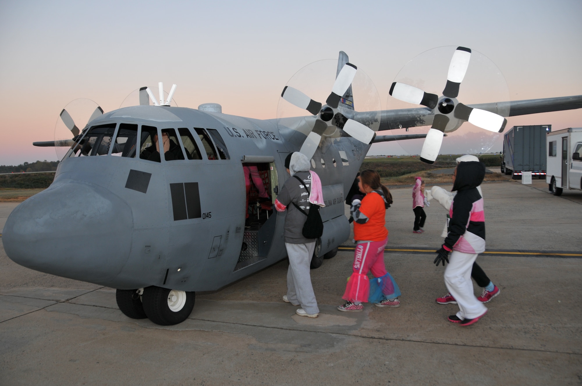 U.S. Air Force members from the 145th Maintenance Squadron, North Carolina Air National Guard give rides to children and other participants on the ever so popular Mini C-130 during the Seventh Annual 5-K Runway Walk/Run held at Charlotte-Douglas Intl. Airport, October 26, 2013.  The replicated Mini C-130 Hercules aircraft and members from the 145th Airlift Wing have supported the Annual 5-K for the last four years, giving back to the community that gives so much to the N.C. Air National Guard. (Air National Guard photo by Master Sgt. Patricia F. Moran/ Released)