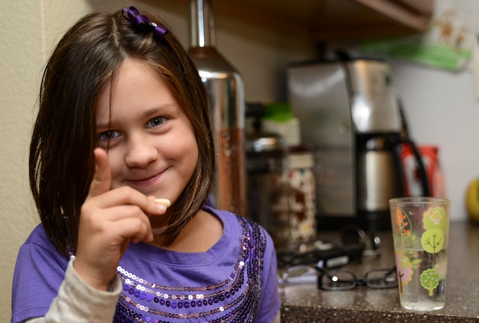 Seven year old Evelyn Hill points as she prepares to take her daily medication Nov. 13, 2013, at Joint Base Charleston – Air Base, S.C. Evelyn is the daughter of Senior Airman Jessica Jordan, 315th Aircraft Maintenance Squadron hydraulic mechanic, and Senior Airman Ryan Jordan, 437th Aircraft Maintenance Squadron electronic warfare technician. Evelyn was diagnosed with epilepsy in 2010 at the age of 4. Epilepsy is a brain disorder in which a person has repeated seizures or convulsions. (U.S. Air Force photo/ Senior Airman Dennis Sloan)