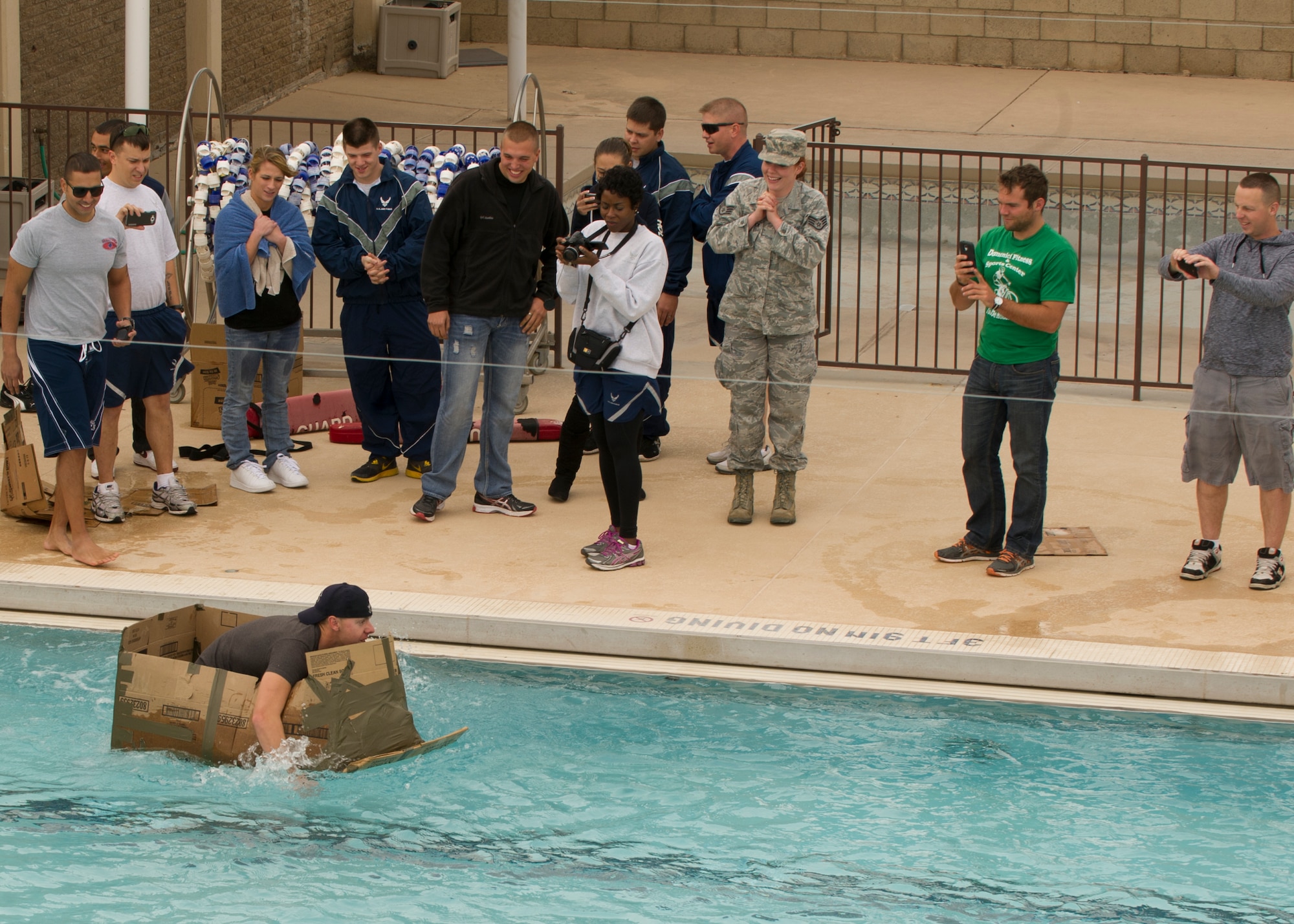 A member of Team Holloman paddles his way to the finish during the cardboard boat race event as part of Sports Day at Holloman Air Force Base N.M., Nov. 15. Sports Day is an annual event held through the Domenici Fitness and Sports Center, in which Holloman units compete against one another in various team and individual events. (U.S. Air Force photo by Airman 1st Class Chase Cannon/Released)