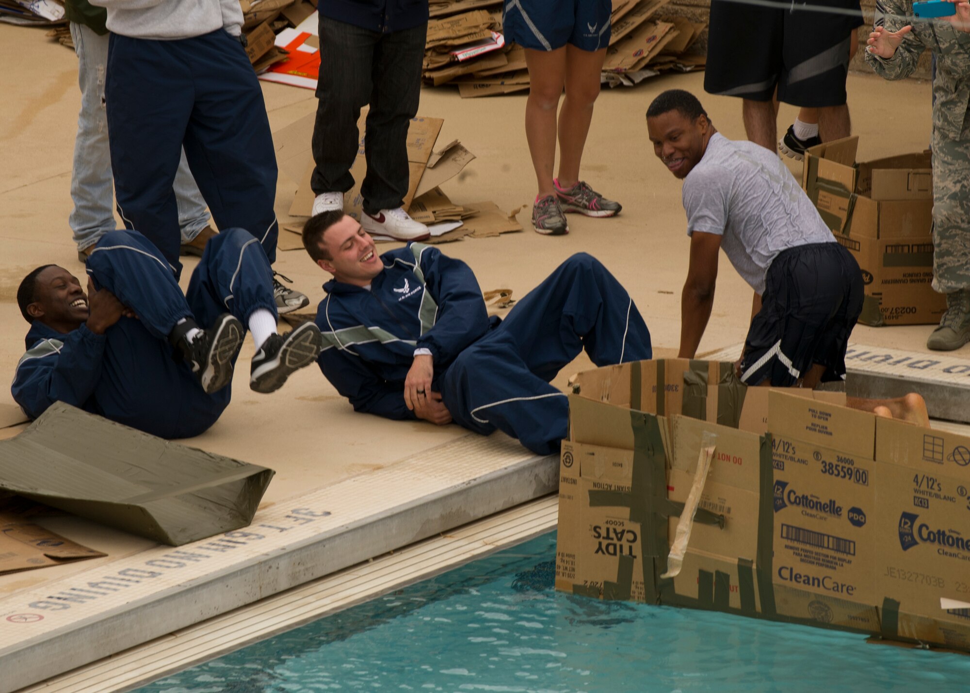 Members of Team Holloman enjoy the camaraderie offered by the Sports Day events at Holloman Air Force Base N.M., Nov. 15.Members of Team Holloman work to build a cardboard boat to race during Sports day at Holloman Air Force Base N.M., Nov. 15. Sports Day is an annual event held through the Domenici Fitness and Sports Center, in which Holloman units compete against one another in various team and individual events. (U.S. Air Force photo by Airman 1st Class Chase Cannon/Released)