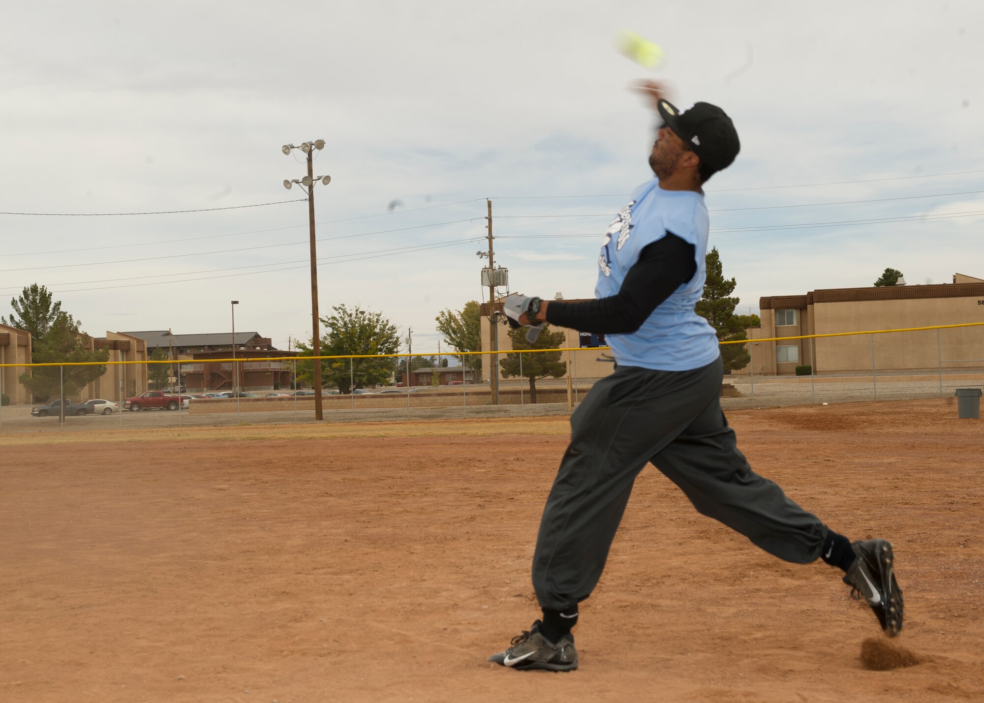A member of Team Holloman throws a softball as a part of the softball pitch event during Sports Day at Holloman Air Force Base N.M., Nov. 15. Sports Day is an annual event held through the Domenici Fitness and Sports Center, in which Holloman units compete against one another in various team and individual events. (U.S. Air Force photo by Airman 1st Class Chase Cannon/Released)