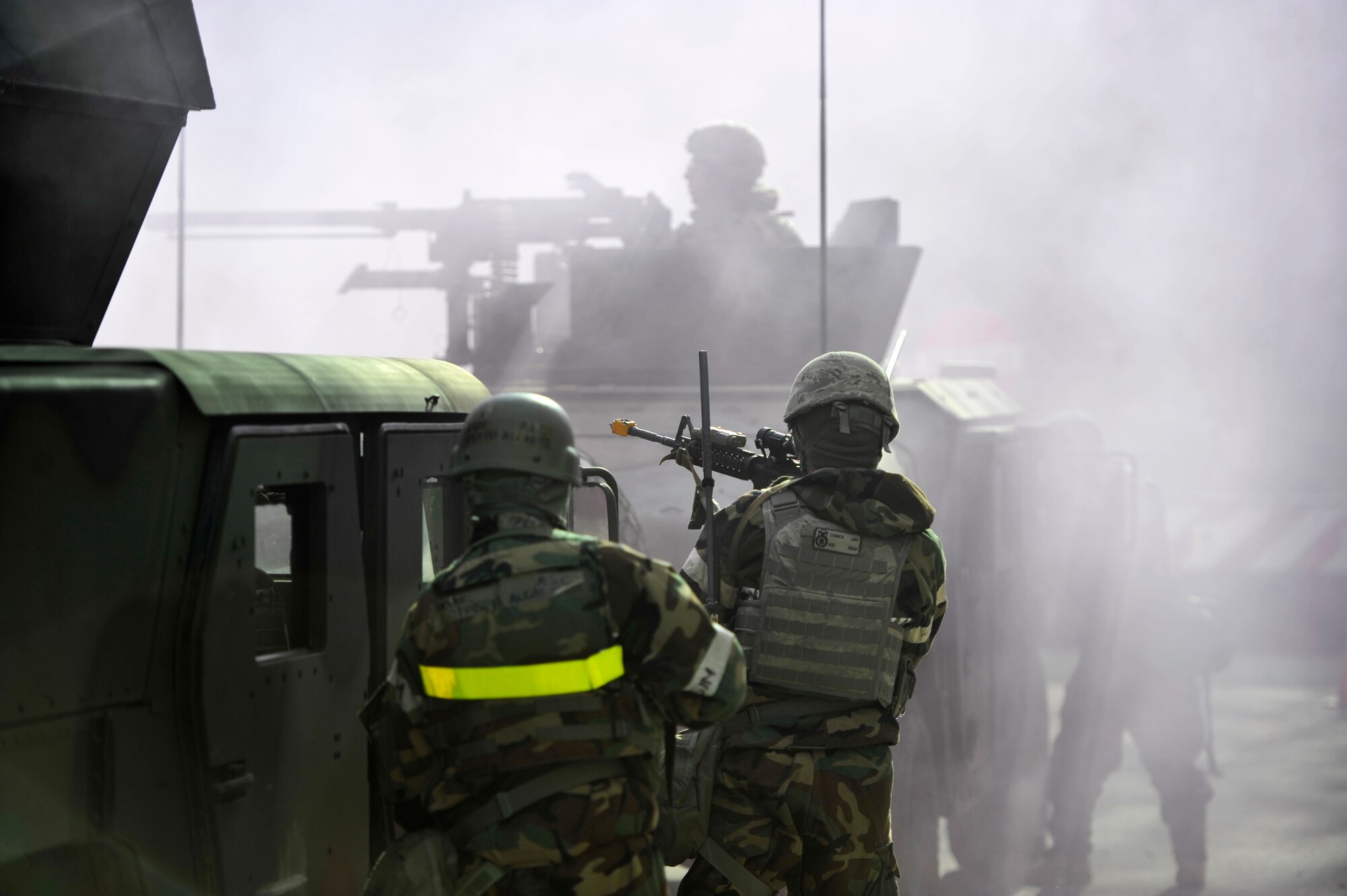 Airmen from the 51st Security Forces Squadron respond to a ground attack outside the 35th Air Defense Artillery Brigade Headquarters during Operational Readiness Exercise Beverly Bulldog 14-01 at Osan Air Base, Republic of Korea, Nov. 20, 2013. Defenders used blank rounds of ammunition and smoke canisters to simulate warfare. (U.S. Air Force photo/Staff Sgt. Emerson Nuñez)