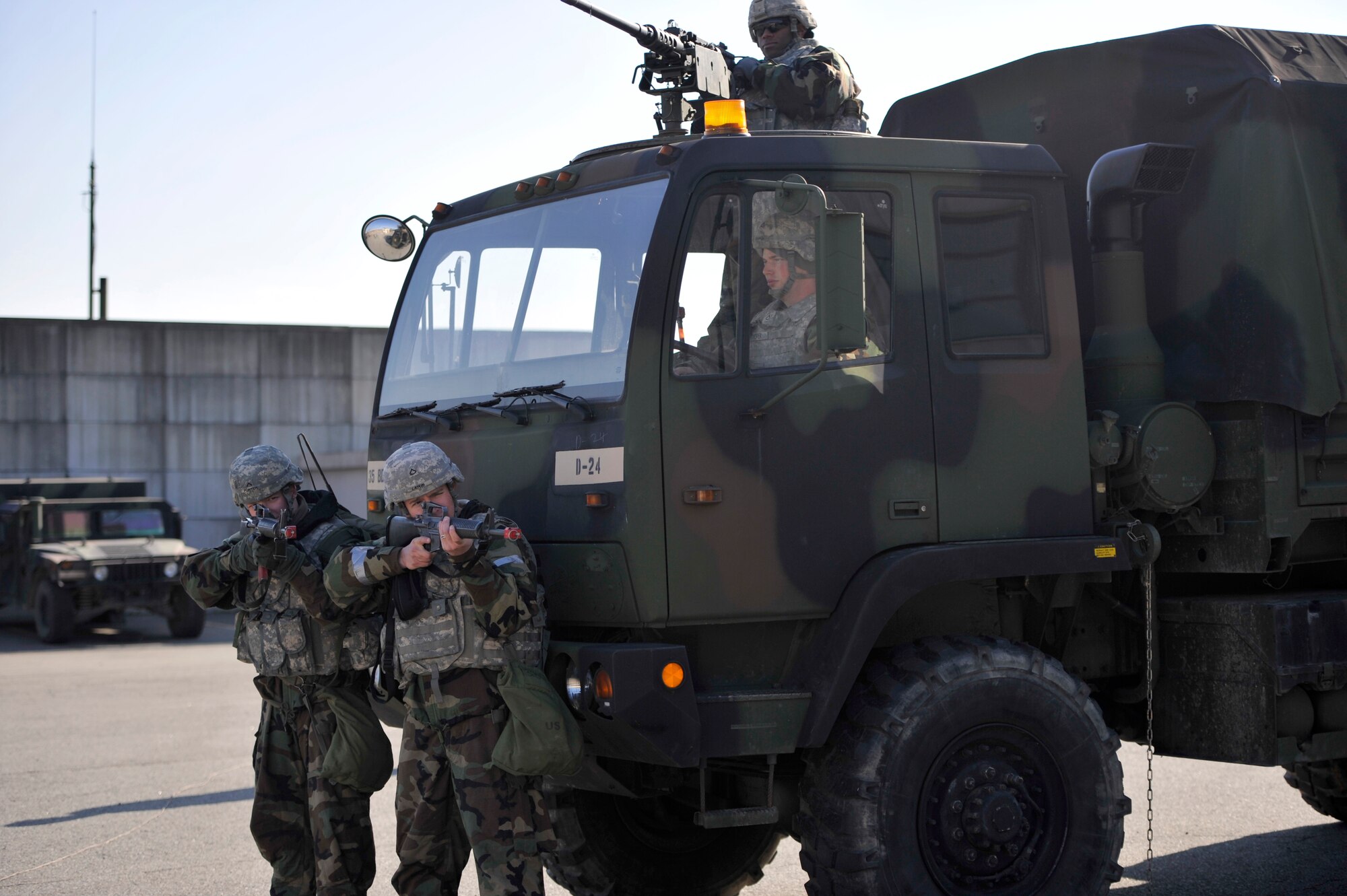U.S. Army Soldiers from the 35th Air Defense Artillery Brigade defend Osan against opposition forces during Operational Readiness Exercise Beverly Bulldog 14-01 at Osan Air Base, Republic of Korea, Nov. 20, 2013. During the week, Osan Airmen will be tested on their ability to utilize their chemical, biological, radiological and nuclear training, as well as administer self aid and buddy care during contingency operations. (U.S. Air Force photo/Staff Sgt. Emerson Nuñez) 