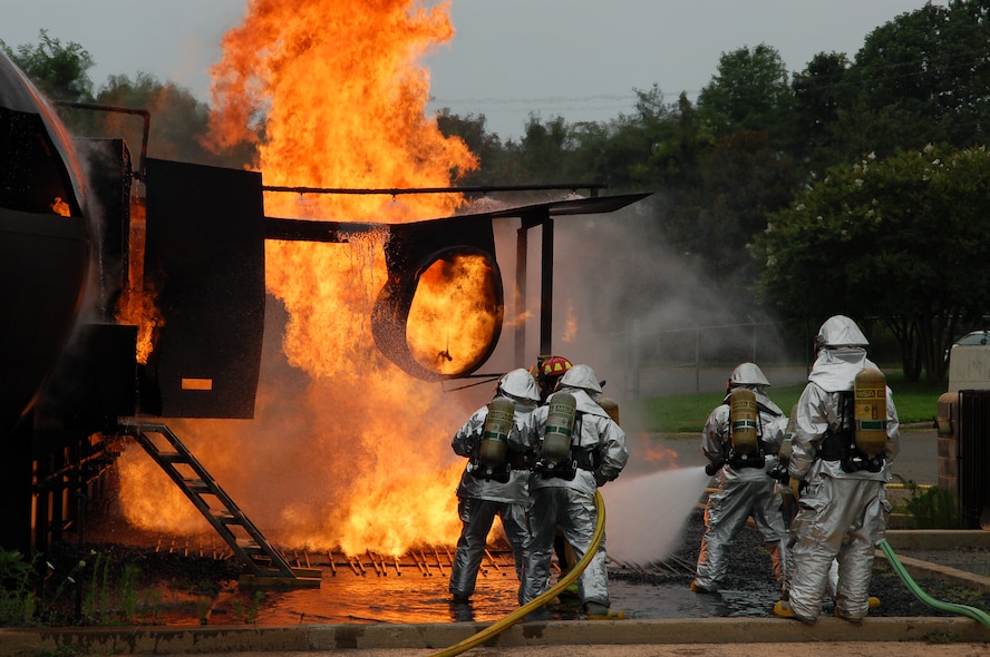 U.S. Air Force members from the 145th Civil Engineer Squadron, North Carolina Air National Guard provide training for other civilian firefighters and North Carolina National Guard Civil Engineer Fire Departments.  The training, which took place July 17, 2013, is designed to prepare firefighters for a scenario in which a plane catches fire on the runway.  Training consists of about 50 burns on a specially designed mock aircraft called the Mobile Aircraft Firefighting Trainer.  At the Charlotte-Douglas Intl. Airport both military and civilian firefighters are assigned to these fire stations. (Air National Guard photo by Staff Sgt. Pamela Robbins/ Released)


